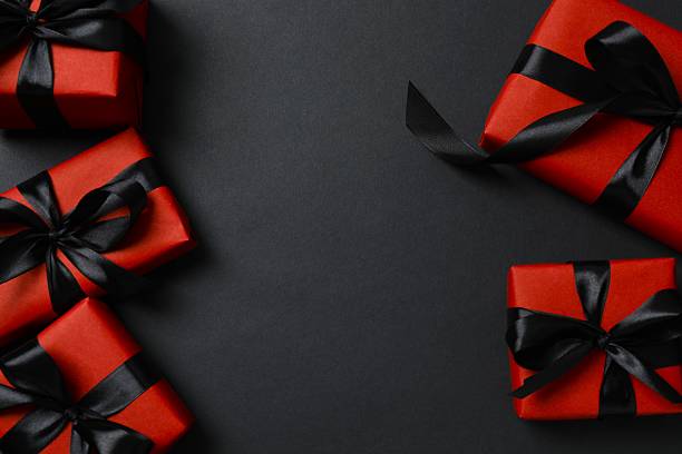 istock Stylish red gift boxes on a black background, festive and holiday concept 2245551792