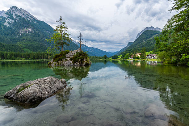 Hintersee Lake and Watzmann Mountain. Reflection on Water. Rocks, Trees and Buildings. Bavaria, Germany