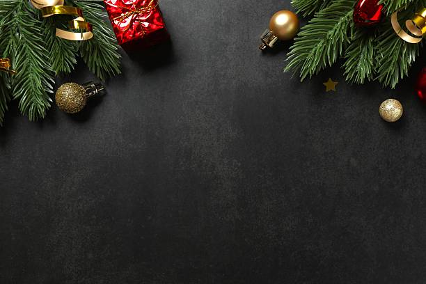 istock Christmas ornaments and pine branches on black background. Flat lay, top view 2245552672