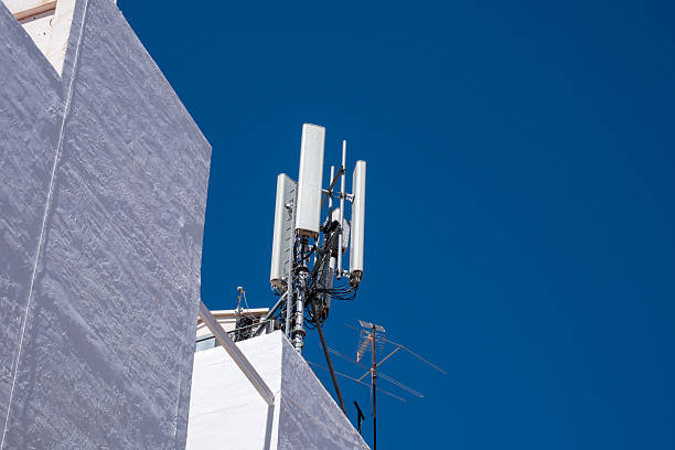 istock Modern urban communication infrastructure with cell tower against clear blue sky 2245554272