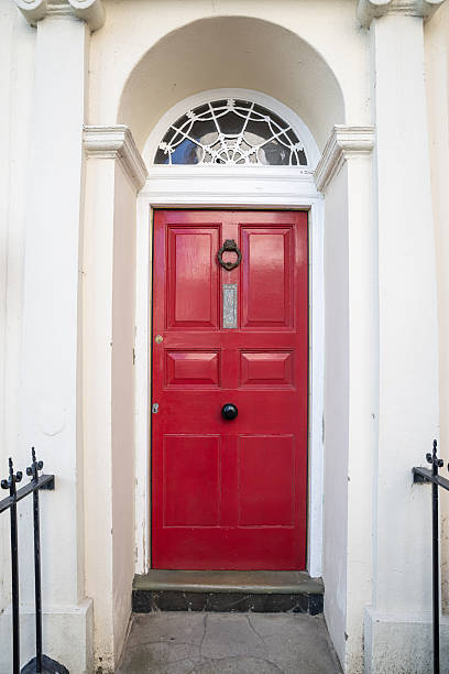 istock Bright red door on a white building. 2245554279