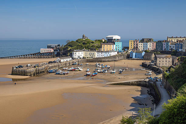 istock Boats stranded on the sand by a low tide in Tenby harbor. 2245554287