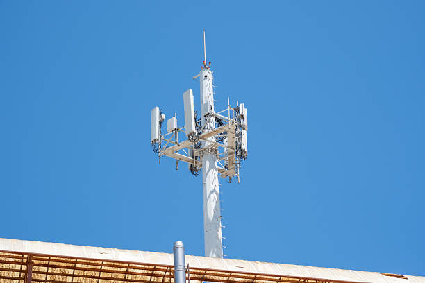 istock Cellular communication tower against clear blue sky on rooftop 2245554434