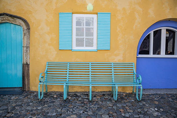 Portmerion, Gwynedd, Wales, United Kingdom. An aqua colored bench in Portmerion.