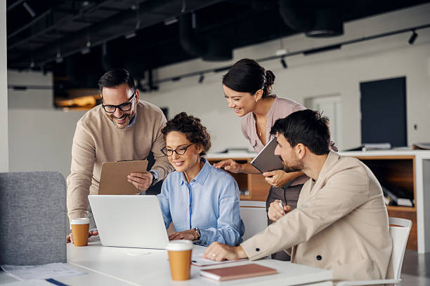 istock Business team collaborating on laptop in modern office 2245556473