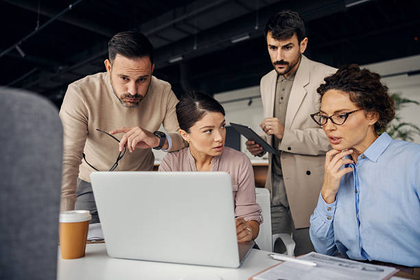 istock Business team collaborating on laptop at office meeting 2245556476