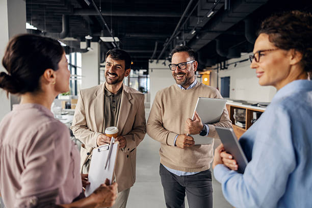 istock Business colleagues talking in modern office workspace 2245556562
