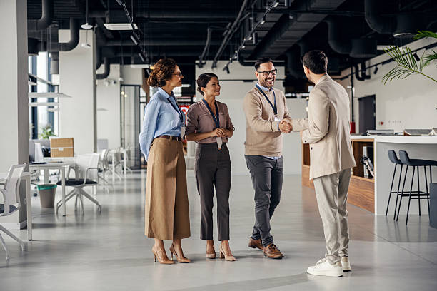 istock Business colleagues shaking hands in modern office 2245556596