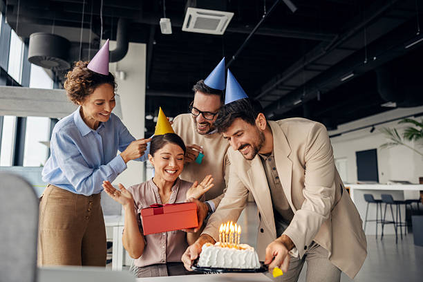 istock Office colleagues celebrating birthday party with cake and gift 2245557192