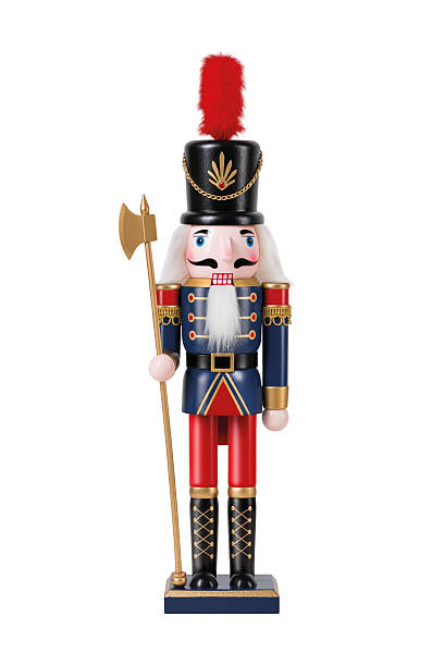 istock Wooden Nutcracker Soldier dressed in a blue and red uniform isolated on a white background. High resolution. 2245557434