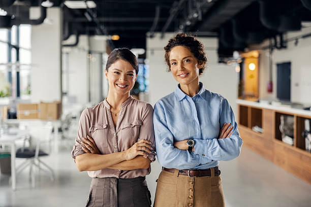 istock Two businesswomen standing confidently in modern office 2245557576