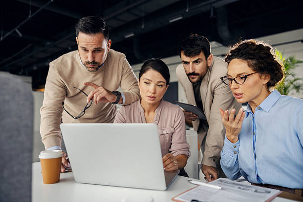 istock Business team collaborating on laptop in modern office 2245557716