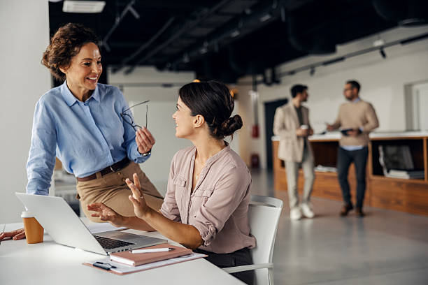 istock Businesswomen collaborating on laptop in modern office 2245557780