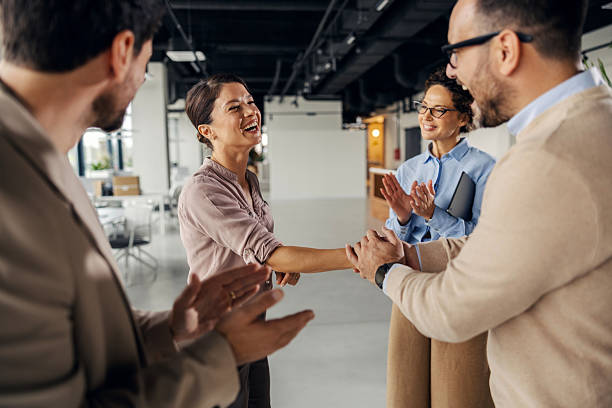 istock Business colleagues shaking hands receiving applause for success 2245557833