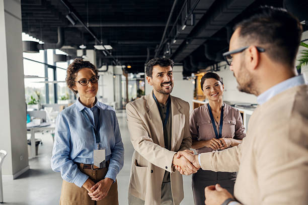 istock Business people shaking hands in modern office 2245557834