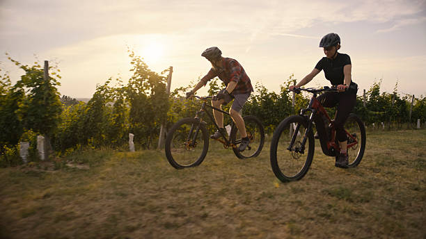istock Mature Caucasian Couple Enjoying a Bicycle Ride Through Vineyard Rows 2245558707