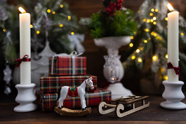 istock New Year's table setting with white candles and an elegant Christmas tree in the background. A festive and New Year's atmosphere. 2245562155