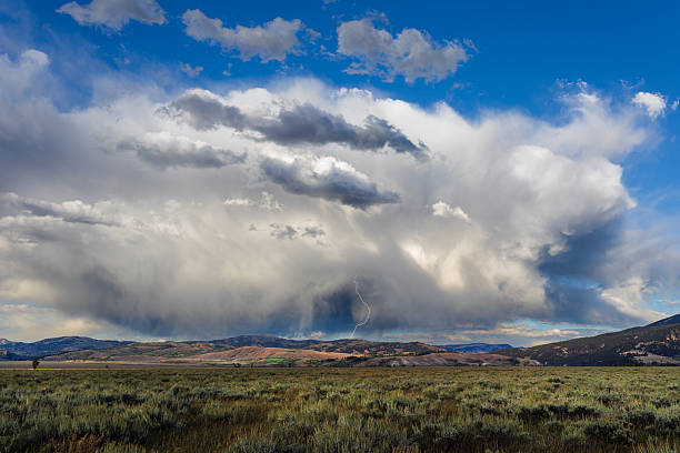 Dramatic sky with storm clouds and lightning over the sagebrush flats in Grand Teton National Park, Wyoming, USA.