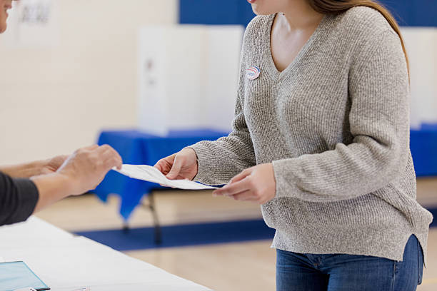 istock Voter receives ballot, participates in democratic process 2245563930