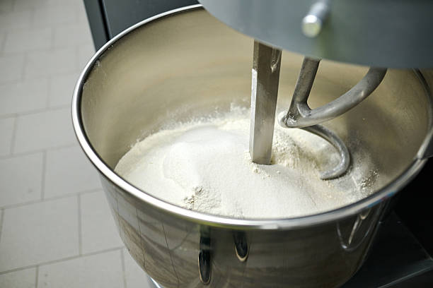 istock Mixing bowl filled with flour and dough hook in a professional kitchen, showcasing baking preparation and culinary artistry in action 2245566049