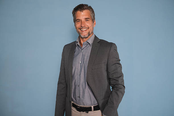 istock Stylish Businessman Posing Against Blue Background 2245566864