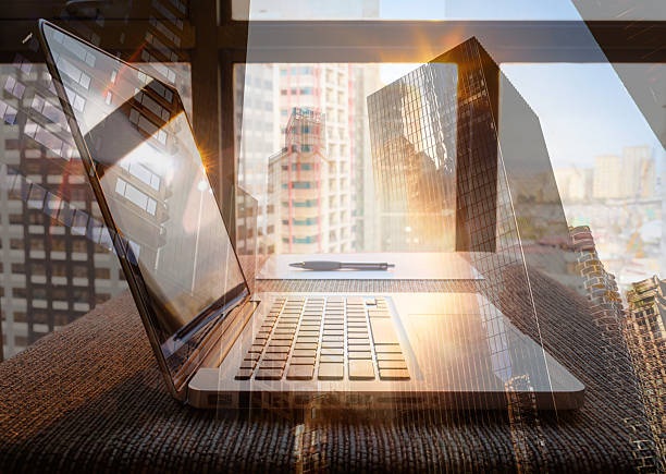 istock Modern Business Technology with Laptop and Cityscape Multiple Exposure 2245567568