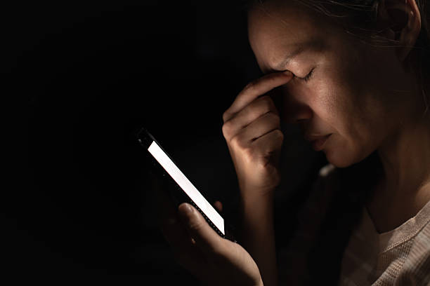 istock Woman Experiencing Eye Strain While Using Smartphone in the Dark 2245567637