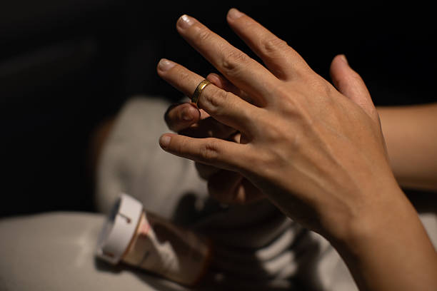 istock Removing Wedding Ring During Emotional Stress – Close-Up of Hands Symbolizing Relationship Struggles and Separation 2245567662