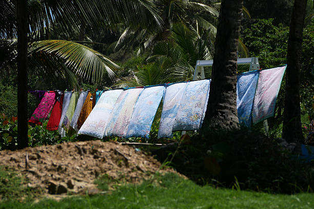 colorful laundry hanging on a line outdoors in between trees