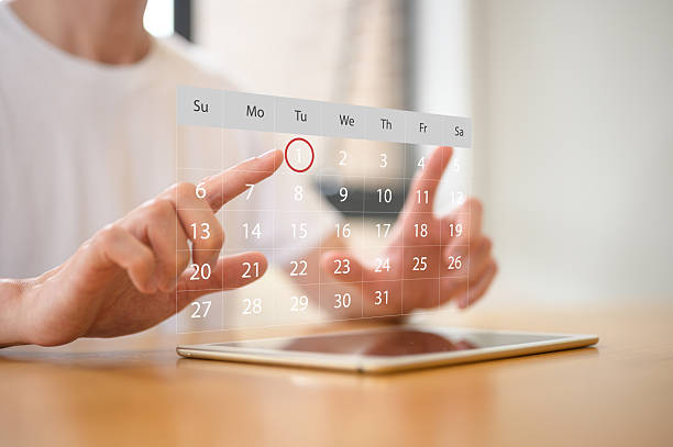istock Businessman meticulously manages their daily schedule using a digital tablet with calendar application, representing schedule planning, appointment management, and time organization concept 2245573334