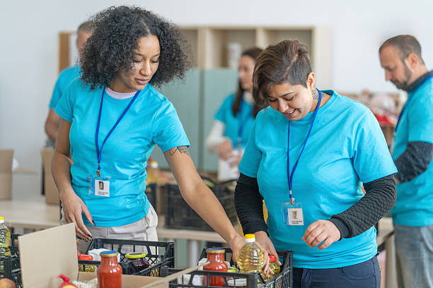 istock Volunteers sorting food into boxes for donation 2245573995