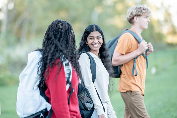 istock Diverse Group Of Students Walking Outdoors, Smiling Friends At A Park Campus 2245574261