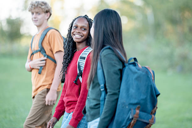 istock Smiling Diverse Teens Walking Together In Park After School With Backpacks 2245574262