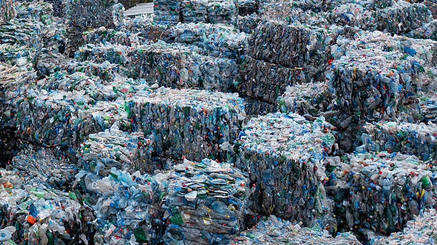 istock Recycling Waste Facility Outdoors With Large Compressed Plastic Bales Stacked In Yard 2245574312