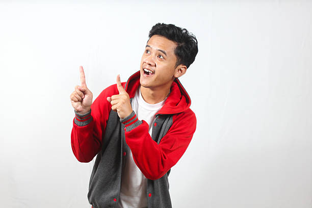 Asia man wearing Hoodie jacket gesture Pointing Upwards with Excitement Expression