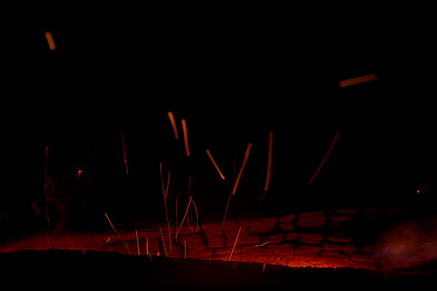 The trail of sparks flying from a bonfire. A depiction of raw energy.