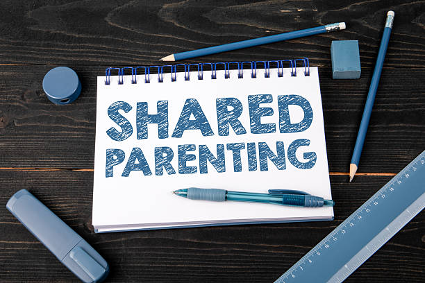 istock Shared Parenting written in notebook on dark wooden desk symbolizing family cooperation responsibility and childcare concept 2245589076