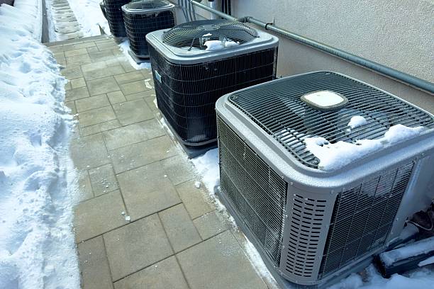 istock Outdoor HVAC units in winter snow 2245590808