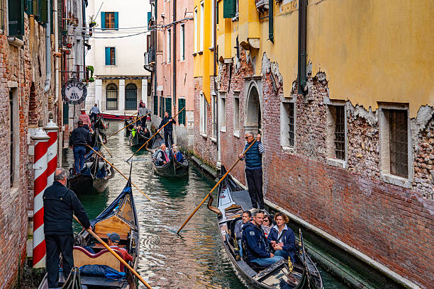 Gondola Sailing in the Venetian Canals with tourist, Venice, Italy.