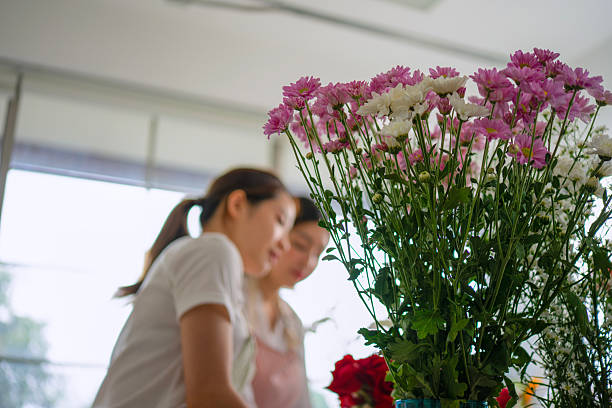 A girl clutches a bouquet of flowers in a crowd