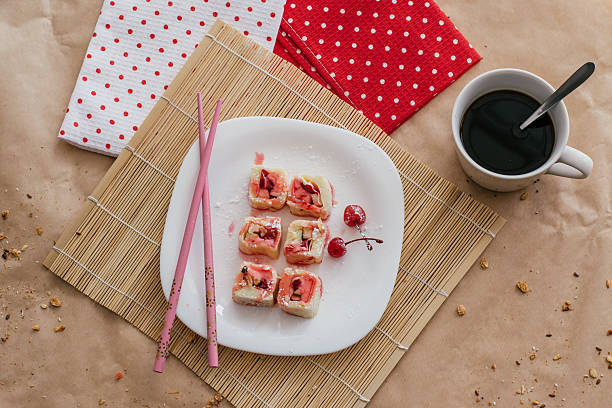 istock sweet sushi featuring cherries on decorative plate in cozy indoor setting. top view. closeup. 2245594438