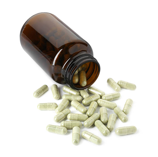 istock Scattered vitamin capsules and bottle isolated on white 2245595802