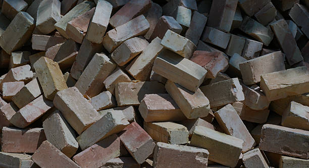 istock yellow brick piled up on the ground 2245598142