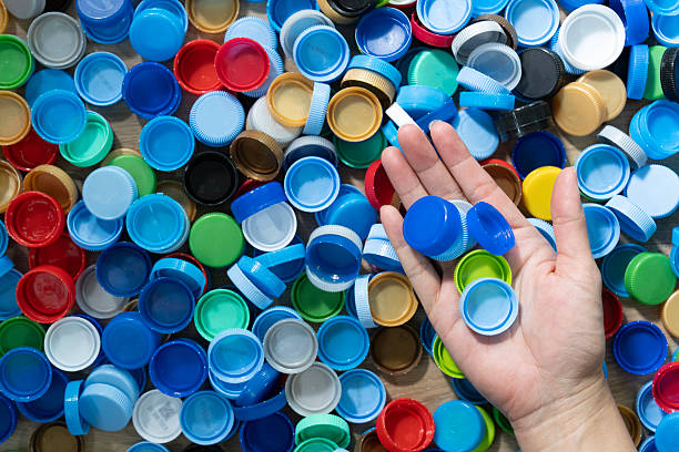 istock Close up hand holding plastic bottles cap for recycling to conse 2245599805