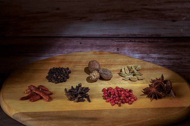 istock Aromatic spices and whole herbs on wooden board 2245603397