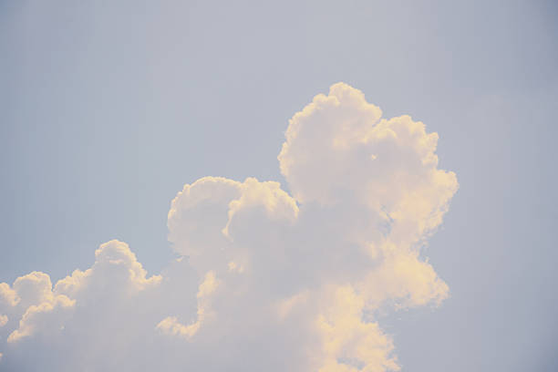 istock Soft, fluffy clouds in a clear blue sky create a serene atmosphere, showcasing the beauty of nature and the tranquility of a sunny day with gentle sunlight 2245604536