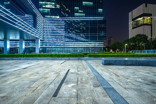 istock Empty brick road nearby office building at night. 2245607092