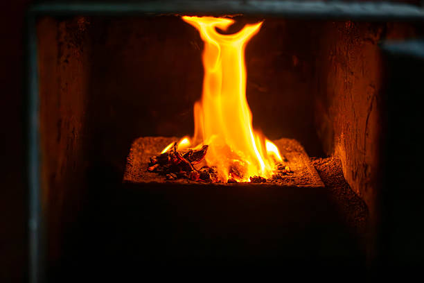 istock Flame in a pellet stove burner inside the combustion chamber, close-up heating process, bright fire and embers in a home boiler room 2245610503