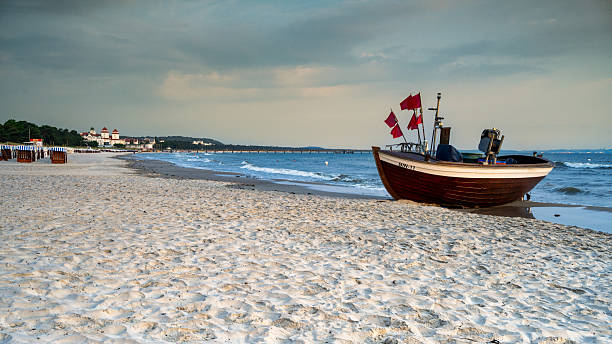 A view of Binz beach with a fishing boat in the background and the pier