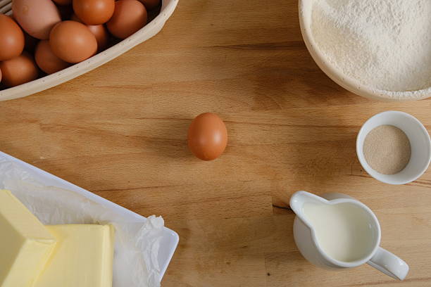 Elevated view of fresh, brown eggs on wooden table